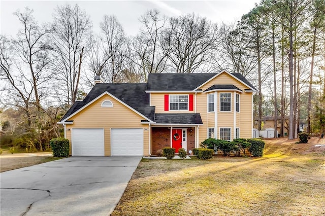 view of property featuring a garage and a front lawn