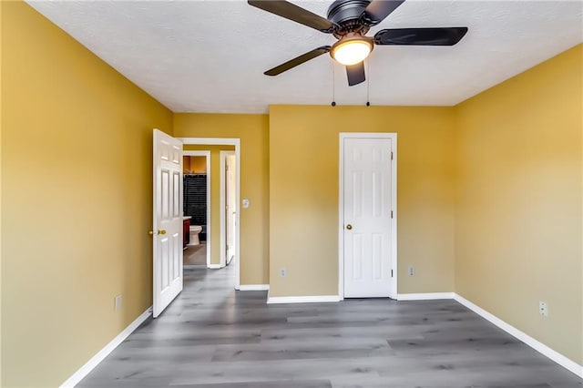 unfurnished bedroom featuring ceiling fan and hardwood / wood-style floors