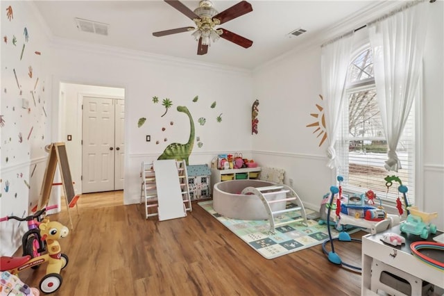 game room featuring hardwood / wood-style floors, ceiling fan, and ornamental molding