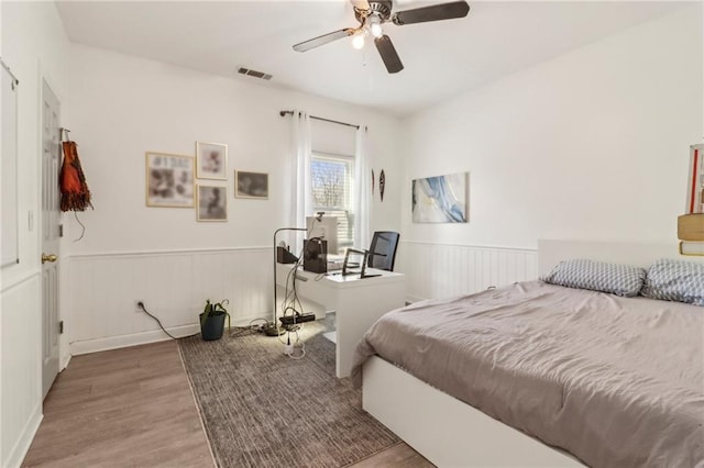 bedroom with wood-type flooring and ceiling fan