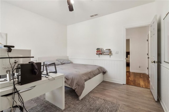 bedroom with ceiling fan and wood-type flooring