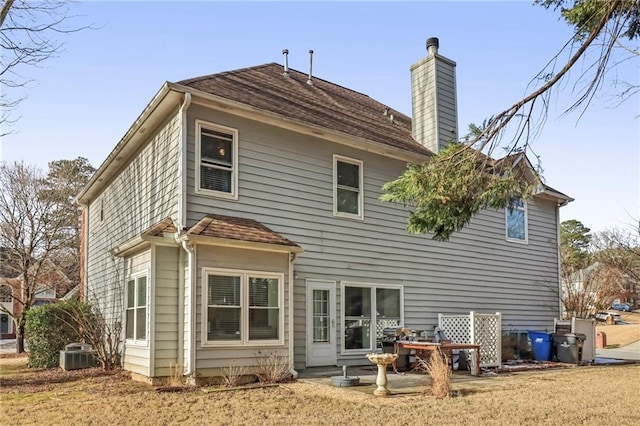 rear view of house with central AC unit and a patio