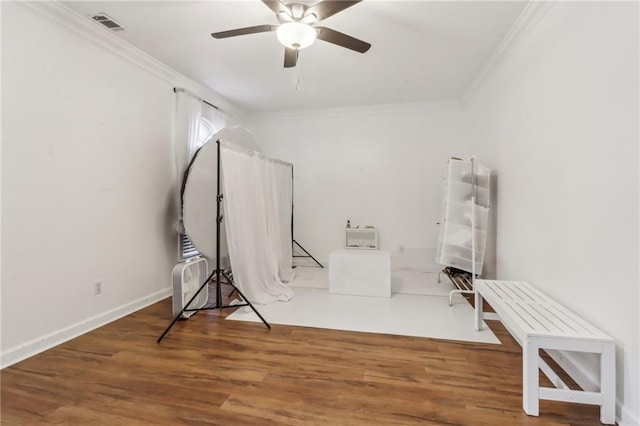 misc room featuring crown molding, hardwood / wood-style flooring, and ceiling fan