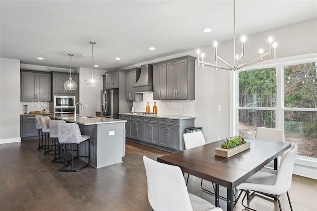 dining area with recessed lighting, dark wood-type flooring, and an inviting chandelier