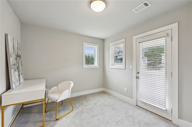 living area featuring visible vents, carpet flooring, and baseboards