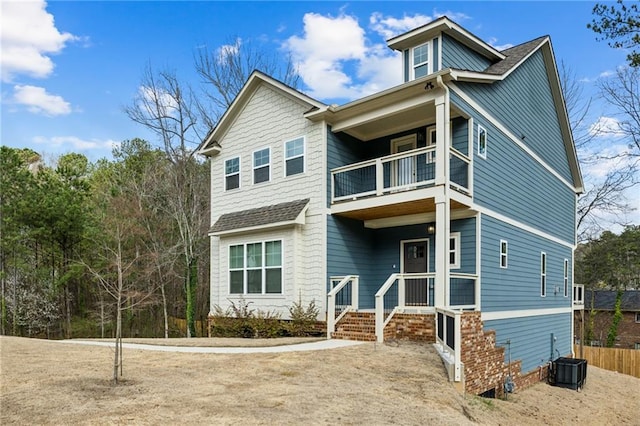 view of front of home with a balcony and cooling unit