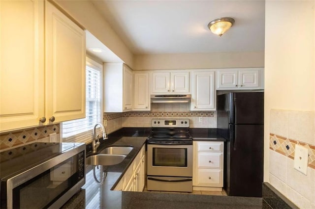 177 NW Amherst Pl, Atlanta, GA 30327 - kitchen featuring white cabinetry, under cabinet range hood, decorative backsplash, a sink, and appliances with stainless steel finishes