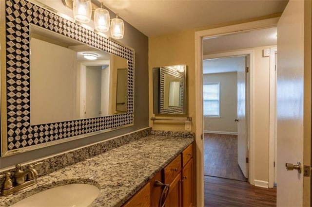 177 NW Amherst Pl, Atlanta, GA 30327 - bathroom featuring vanity, baseboards, and wood finished floors