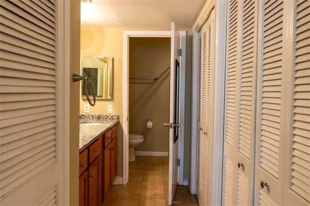 177 NW Amherst Pl, Atlanta, GA 30327 - bathroom with tile patterned floors, a closet, toilet, vanity, and baseboards
