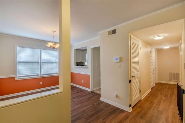 177 NW Amherst Pl, Atlanta, GA 30327 - hallway with baseboards, visible vents, an inviting chandelier, and wood finished floors