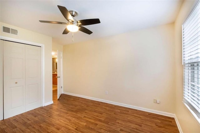 177 NW Amherst Pl, Atlanta, GA 30327 - unfurnished bedroom featuring a closet, a ceiling fan, wood finished floors, baseboards, and visible vents