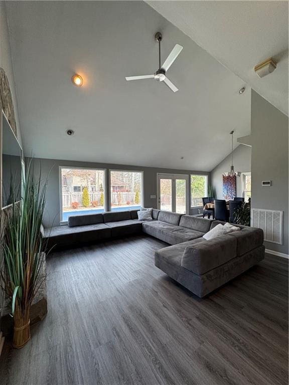 living area featuring dark wood-style floors, high vaulted ceiling, ceiling fan, and visible vents