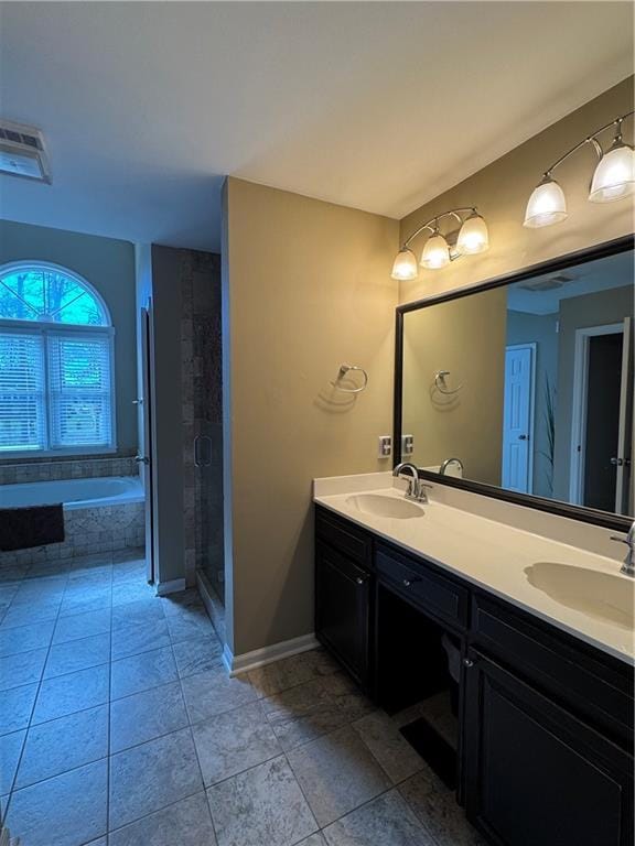 bathroom featuring a stall shower, a sink, a bath, and double vanity