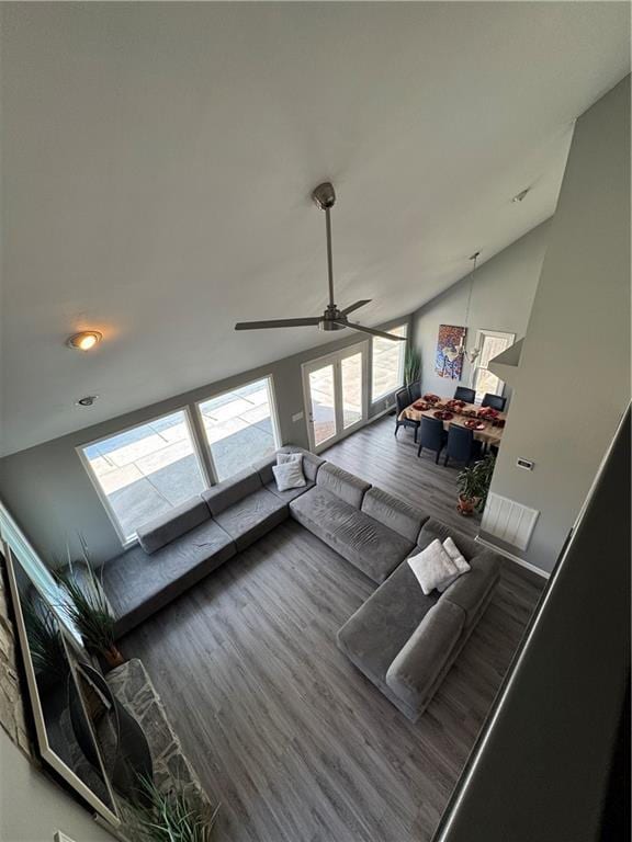 living room with vaulted ceiling and wood finished floors