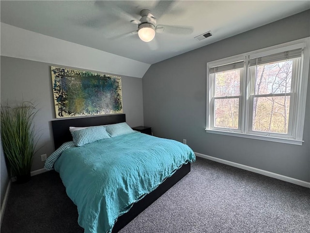 bedroom featuring visible vents, baseboards, a ceiling fan, carpet, and vaulted ceiling