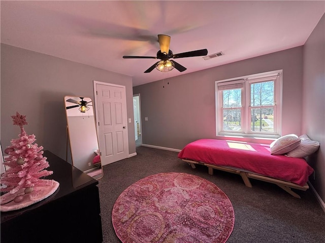 carpeted bedroom featuring baseboards, visible vents, and a ceiling fan