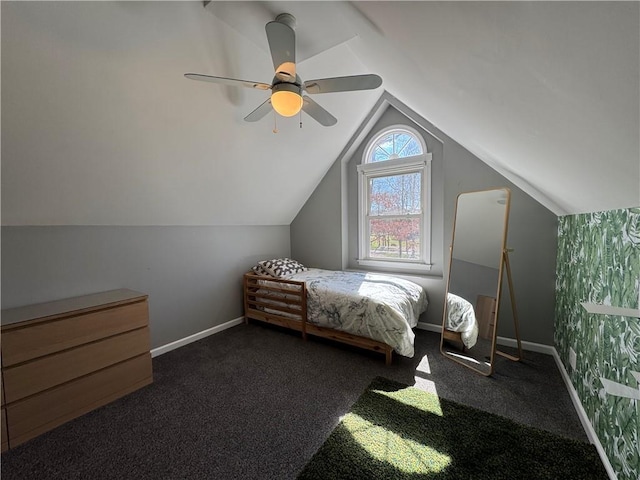 bedroom featuring a ceiling fan, lofted ceiling, carpet, and baseboards