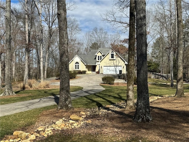 view of front of property with driveway, a garage, and a front yard