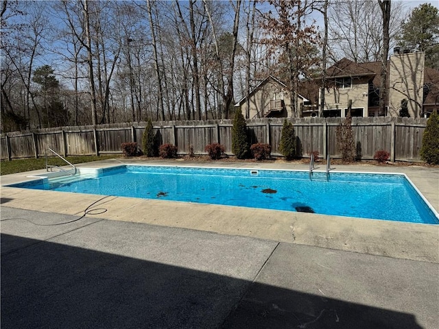 view of pool featuring a patio area, a fenced backyard, and a fenced in pool