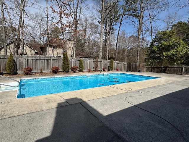 view of swimming pool with a patio, a fenced backyard, and a fenced in pool