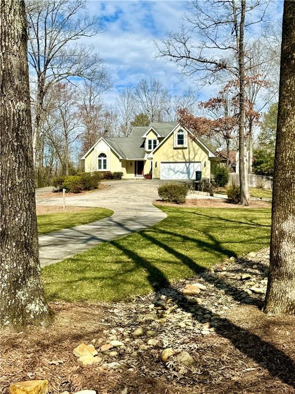 view of yard with driveway and an attached garage