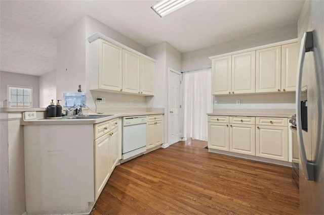 kitchen featuring white dishwasher, dark wood-style flooring, a sink, refrigerator with ice dispenser, and light countertops