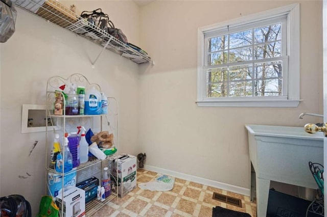 clothes washing area featuring laundry area, baseboards, visible vents, tile patterned floors, and hookup for a washing machine