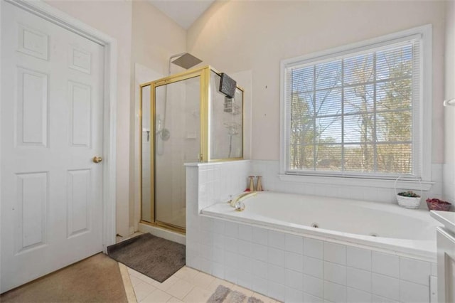 full bathroom featuring a shower stall, a tub with jets, and tile patterned floors