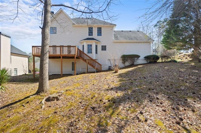 rear view of house featuring stairway and a deck