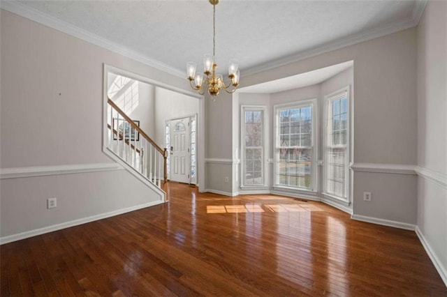 interior space featuring ornamental molding, wood-type flooring, and stairs