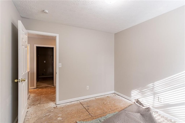 empty room featuring a textured ceiling