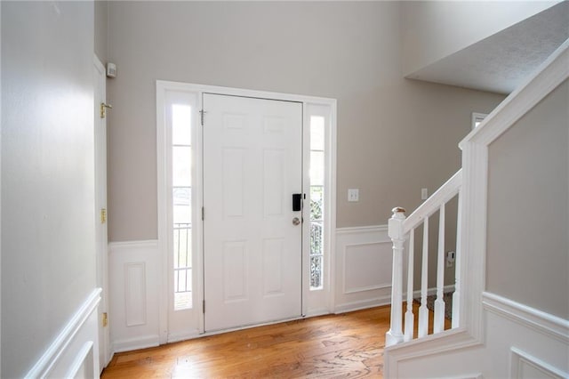 foyer entrance with light hardwood / wood-style floors and plenty of natural light