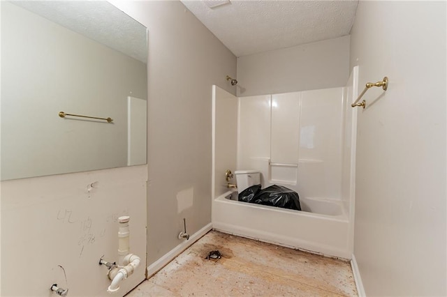 bathroom with shower / bathtub combination and a textured ceiling