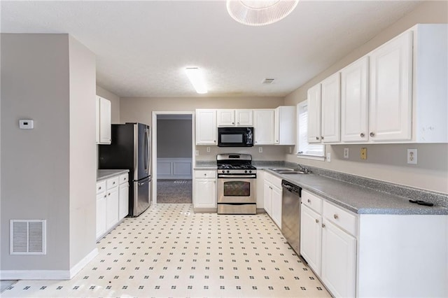 kitchen featuring sink, white cabinets, and appliances with stainless steel finishes