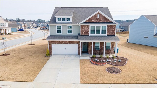 view of front of property featuring a porch and a garage