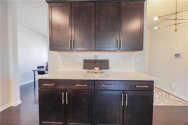 kitchen featuring dark brown cabinetry, backsplash, vaulted ceiling, and dark hardwood / wood-style floors