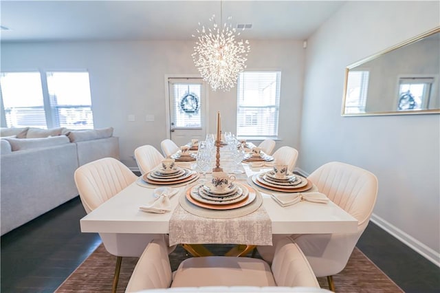 dining room featuring an inviting chandelier and dark hardwood / wood-style flooring