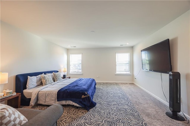 carpeted bedroom featuring multiple windows