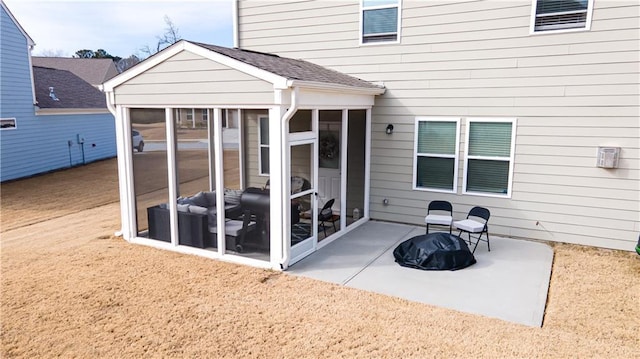 back of house featuring a patio and a sunroom