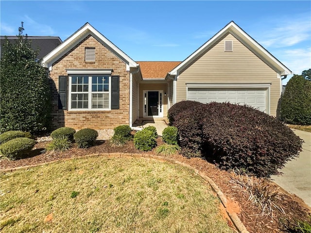 view of front of property with a front yard and a garage