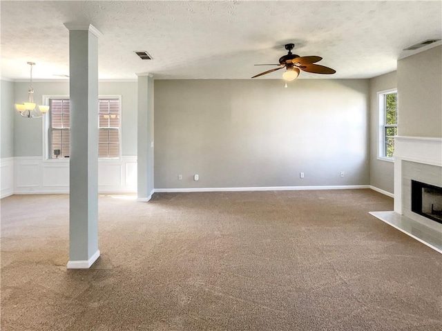 unfurnished living room featuring a textured ceiling, carpet flooring, and ceiling fan with notable chandelier