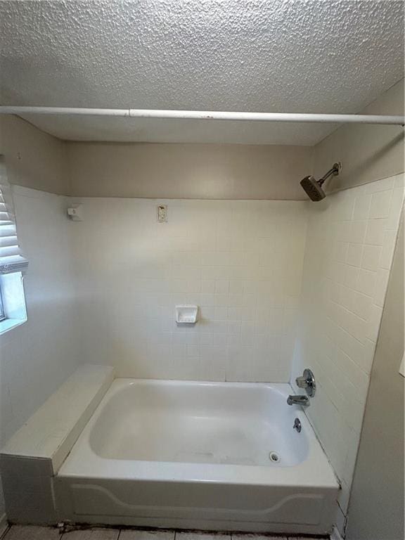 1182 Sims St SW, Atlanta, GA 30310 - bathroom with a textured ceiling and tub / shower combination