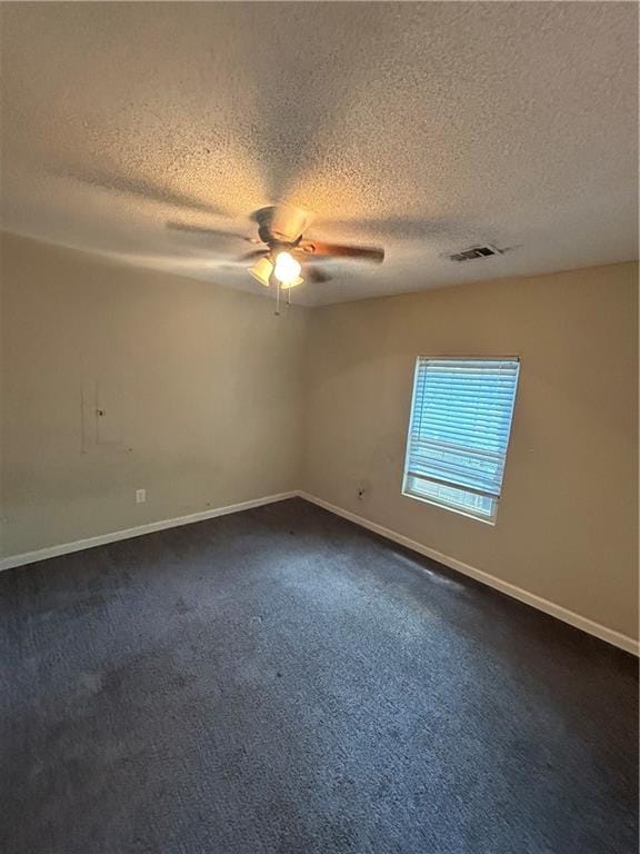 1182 Sims St SW, Atlanta, GA 30310 - unfurnished room featuring a ceiling fan, a textured ceiling, dark colored carpet, and baseboards