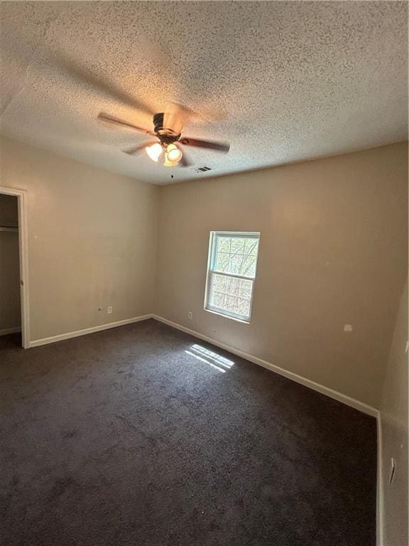 1182 Sims St SW, Atlanta, GA 30310 - empty room with a ceiling fan, dark carpet, a textured ceiling, and baseboards