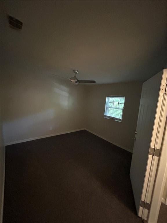 1182 Sims St SW, Atlanta, GA 30310 - empty room featuring dark colored carpet, ceiling fan, and baseboards
