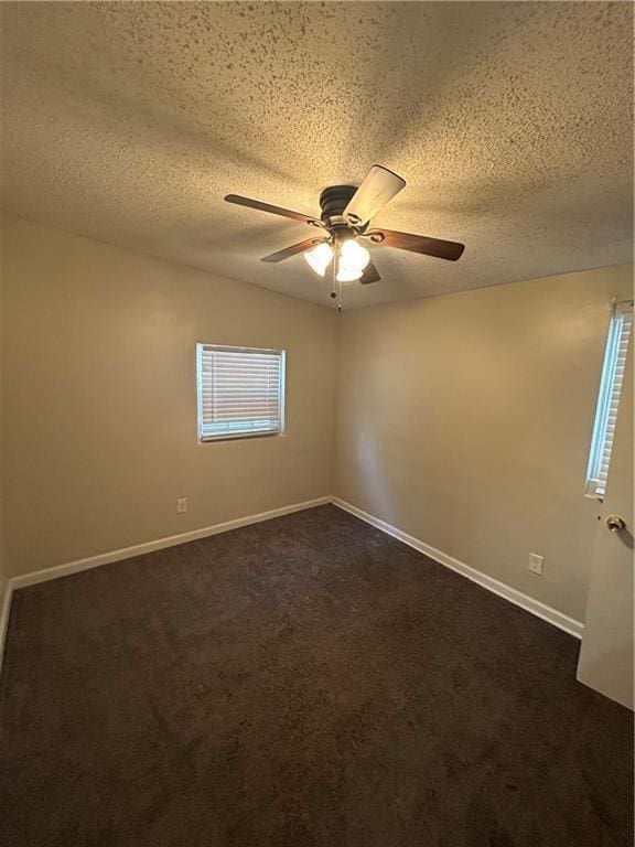 1182 Sims St SW, Atlanta, GA 30310 - empty room with a ceiling fan, dark colored carpet, a textured ceiling, and baseboards