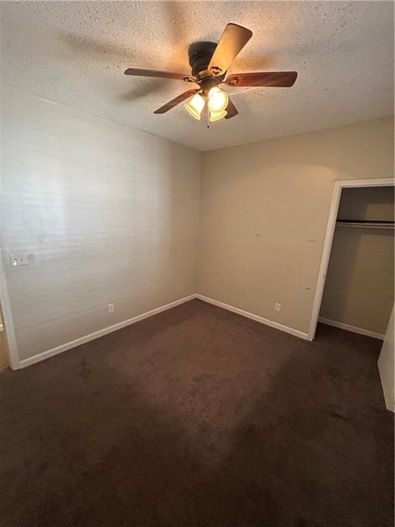1182 Sims St SW, Atlanta, GA 30310 - unfurnished bedroom featuring a textured ceiling, a closet, dark colored carpet, baseboards, and a ceiling fan