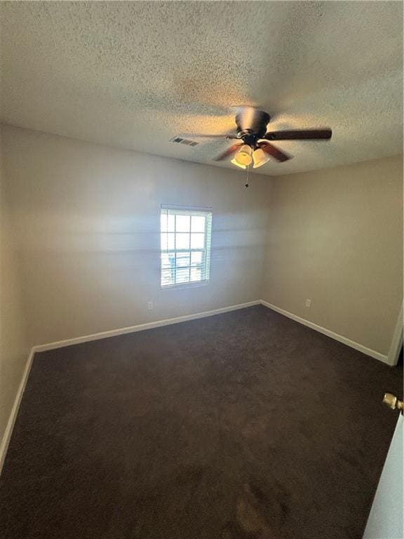 1182 Sims St SW, Atlanta, GA 30310 - spare room with baseboards, dark carpet, a ceiling fan, and a textured ceiling