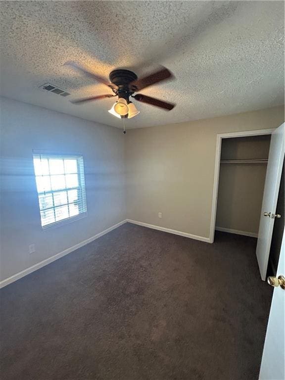 1182 Sims St SW, Atlanta, GA 30310 - unfurnished bedroom with a textured ceiling, dark colored carpet, baseboards, and ceiling fan
