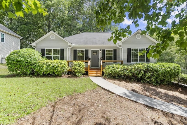 ranch-style house featuring a porch and a front lawn